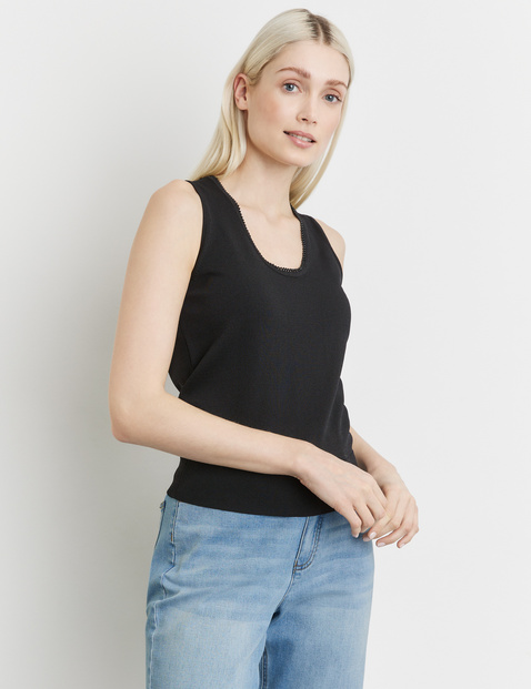 Knitted top with a beaded edge at the neckline