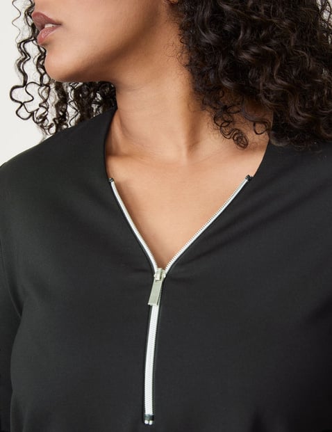 Flared long sleeve top with a zip