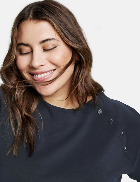 Sweatshirt with a decorative button placket