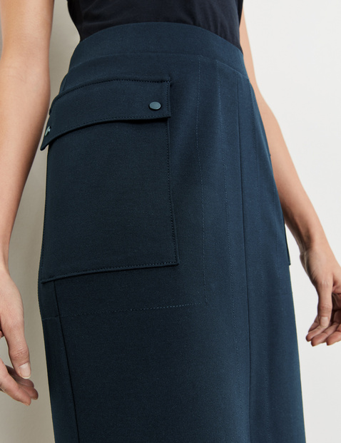 Simple skirt with patch pockets and a kick pleat