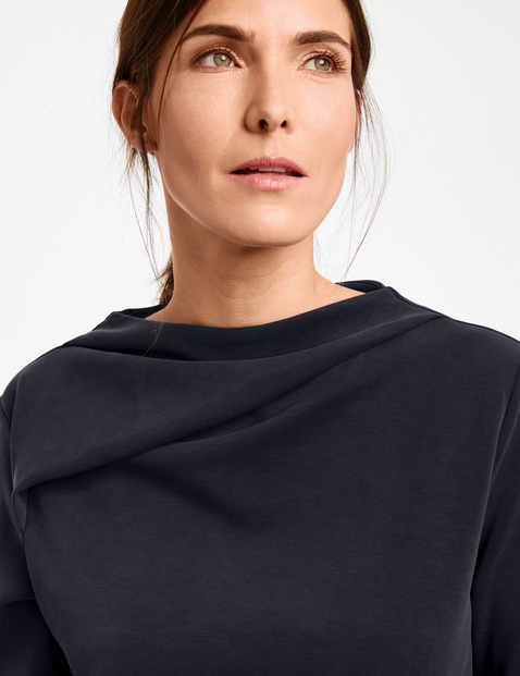 Long sleeve top with a draped cup collar
