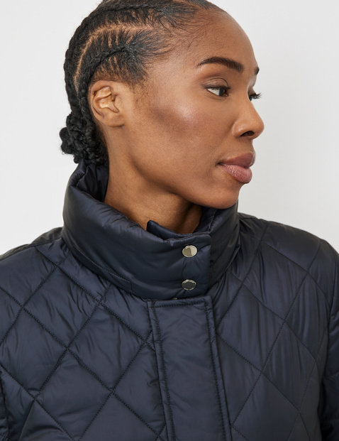 Quilted jacket with a stand-up collar and patch pockets