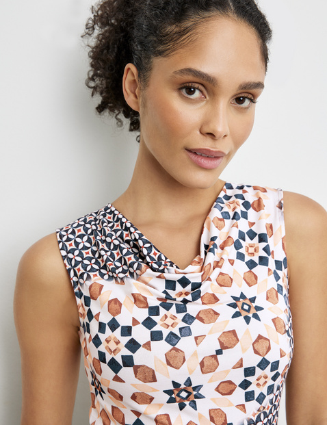 Patterned top with a cowl neckline