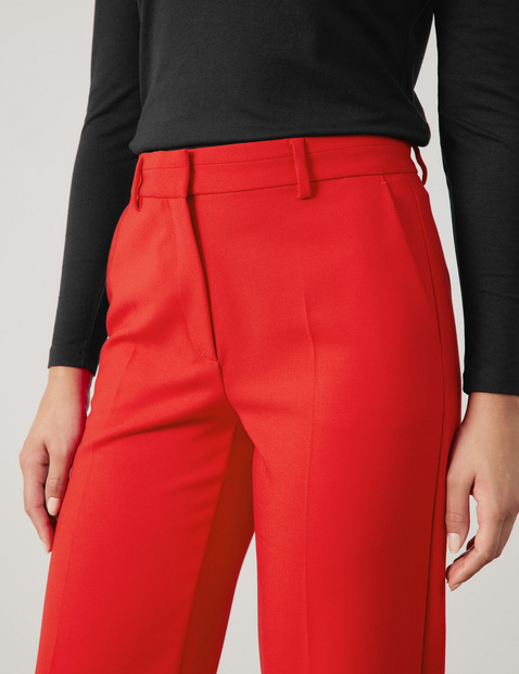 Flowing trousers with pressed pleats