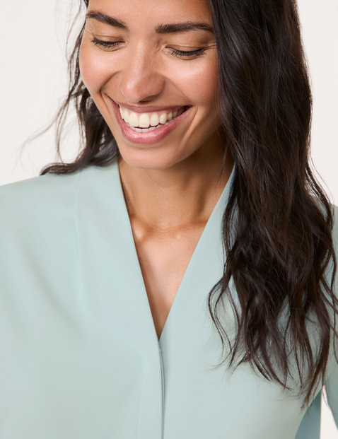 Flowing blouse with decorative pleats