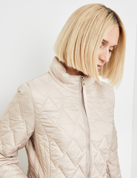Quilted jacket with a decorative topstitched pattern in Beige