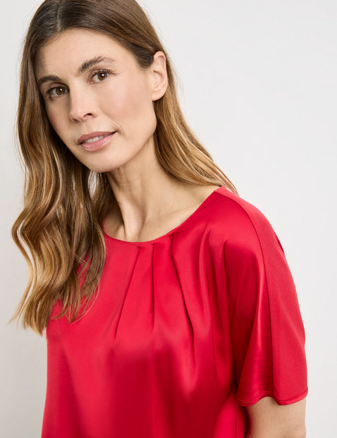 Flowing blouse top with fabric panelling